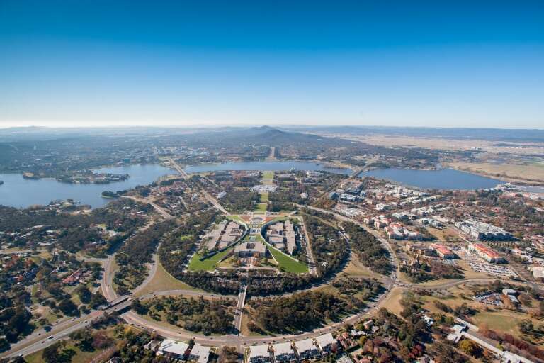 Aerial view over parliament house and Lake Burley Griffin in Canberra, Australian Capital Territory © VisitCanberra