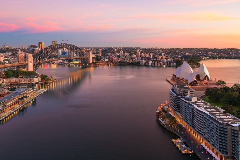 Sun rising over Sydney Harbour and Circular Quay, Sydney, New South Wales © Destination NSW