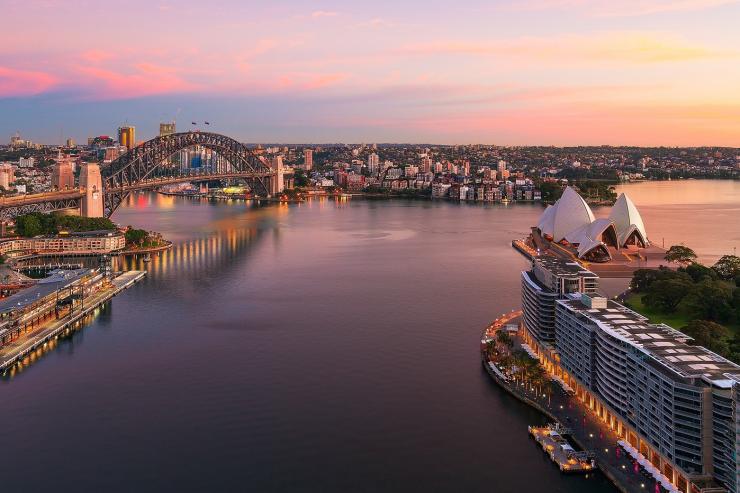 Sun rising over Sydney Harbour and Circular Quay, Sydney, New South Wales © Destination NSW