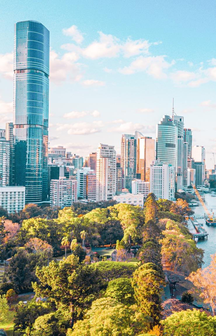 An aerial view captures modern skyscrapers rising beside lush parklands along the river in Brisbane, Queensland © Tourism and Events Queensland. © Tourism and Events Queensland