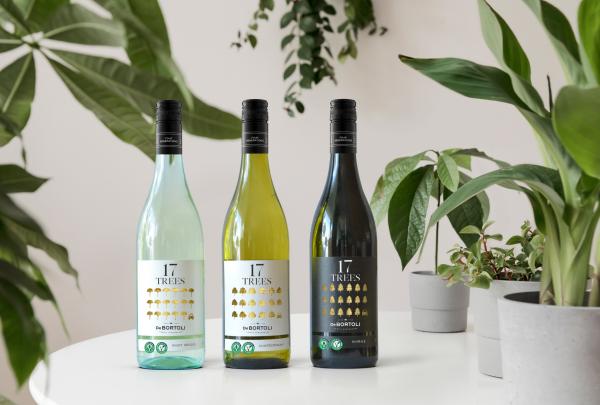 Three wine bottles from the 17 TREES range by De Bortoli Wines sit on a white table surrounded by vibrant potted plants in Bilbul, New South Wales © De Bortoli Wines