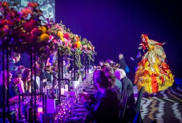 A long dining table adorned with lush floral greenery and surrounded by teal wire chairs fills a heritage hall with ornate ceilings, George Ballroom, St Kilda, Melbourne, Victoria. © Onstage Entertainment