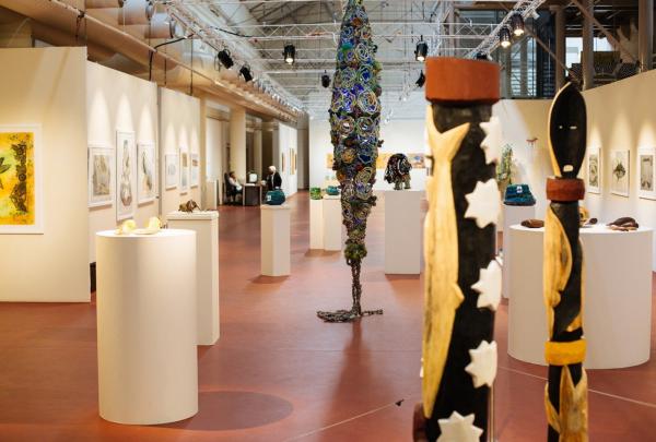 Indigenous sculptures and artwork stand on pedestals throughout the spacious gallery at Tandanya - National Aboriginal Cultural Institute, Adelaide, South Australia. © South Australia Tourism Commission & Adam Bruzzone