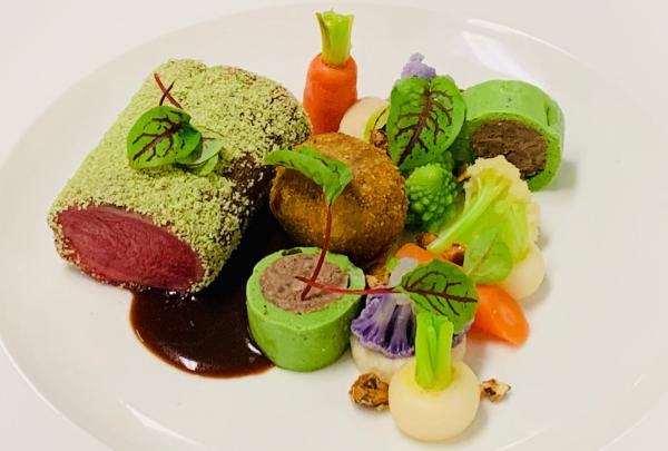 Herb-crusted beef loin is served alongside a croquette, delicate green roulades, baby vegetables, and rich jus at Perth Convention Exhibition Centre, Perth, Western Australia. © Perth Convention Exhibition Centre