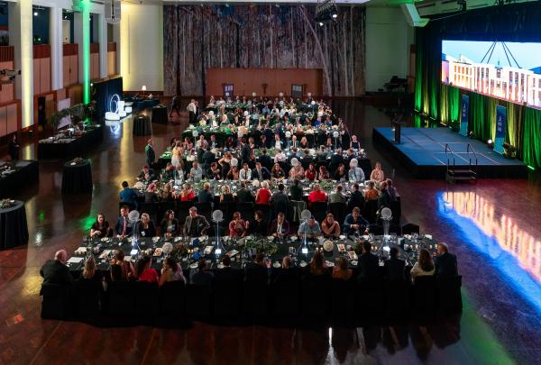 Guests seated at long dining tables during a formal banquet event inside the Great Hall at Parliament House, Canberra, Australian Capital Territory. © Bradley Cummings