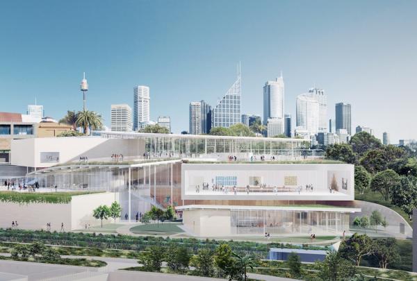 Modern glass and stone pavilion architecture steps down a green hillside towards the harbour against the city skyline, Sydney Modern Project, Sydney, New South Wales. © Art Gallery of New South Wales