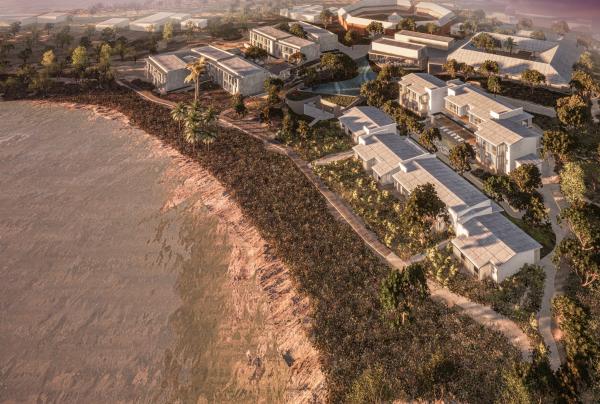 Aerial view of The Lodge Wadjemup on Rottnest Island, Perth, Western Australia, showing modern resort buildings tucked alongside lush green foliage and warm, sunlit coastal waters. © The Lodge Wadjemup