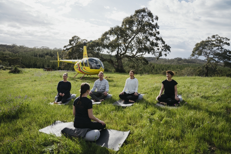 A group yoga session in the Barossa Valley in The Kaiserstuhl Conservation Park, South Australia © Barossa Helicopters