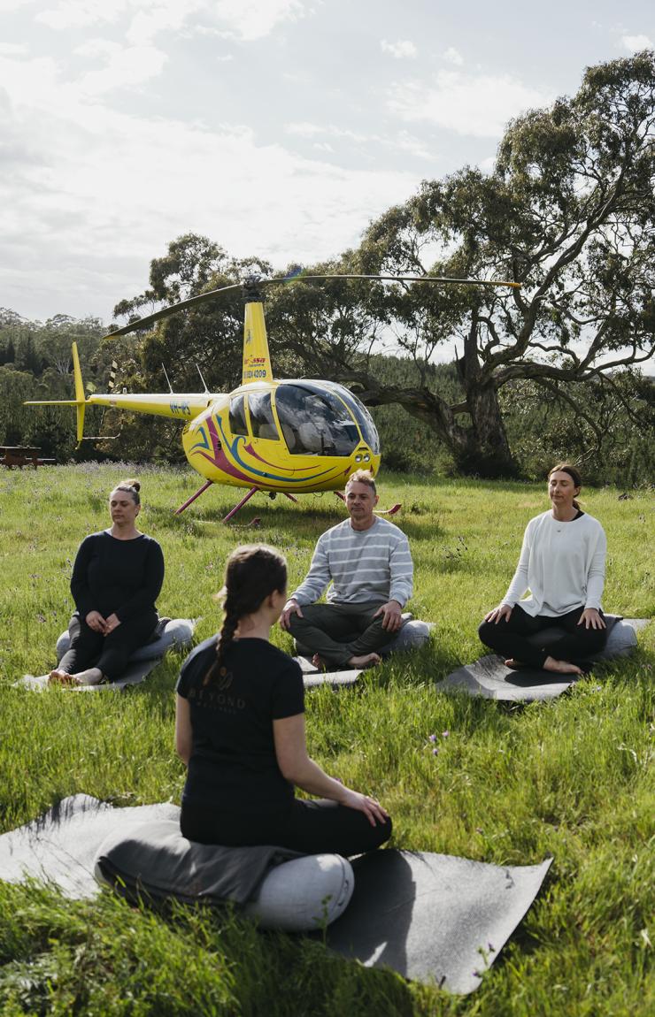 A group yoga session in the Barossa Valley in The Kaiserstuhl Conservation Park, South Australia © Barossa Helicopters A group yoga session in the Barossa Valley in The Kaiserstuhl Conservation Park, South Australia © Barossa Helicopters
