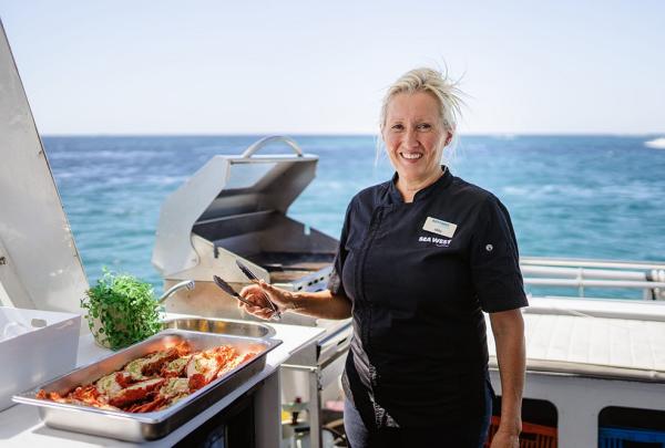 Chef cooking on a boat, Rottnest Island, Western Australia © Tourism Australia