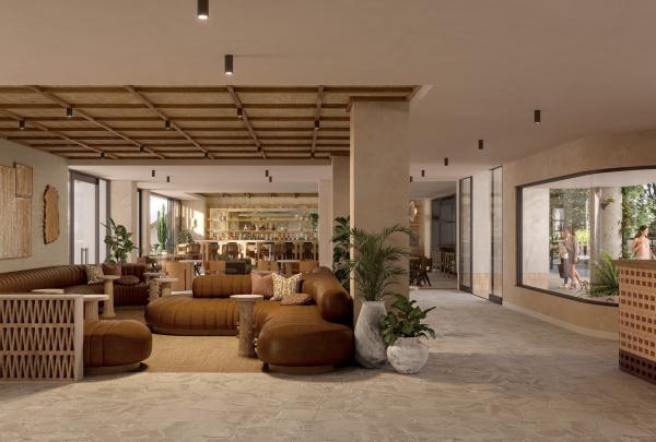 The stylish, earthy hotel lobby lounge at Hyde Perth in Western Australia features curved brown leather sofas, textured stone flooring, lush potted plants, and a wooden latticed ceiling, with a chic bar visible in the background. © Hyde Perth