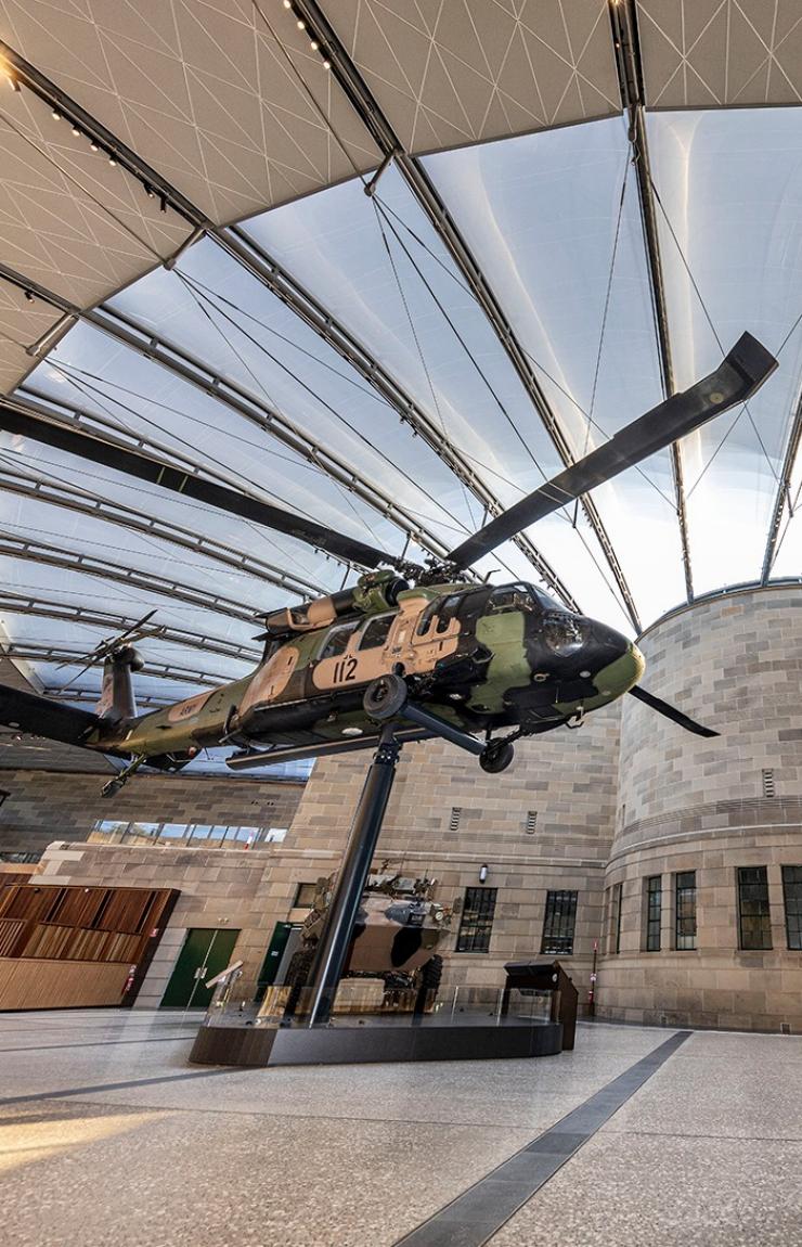 View of the Atrium showing the helicopter, fighter jet and tank under the expansive glazed roof © Australian War Memorial