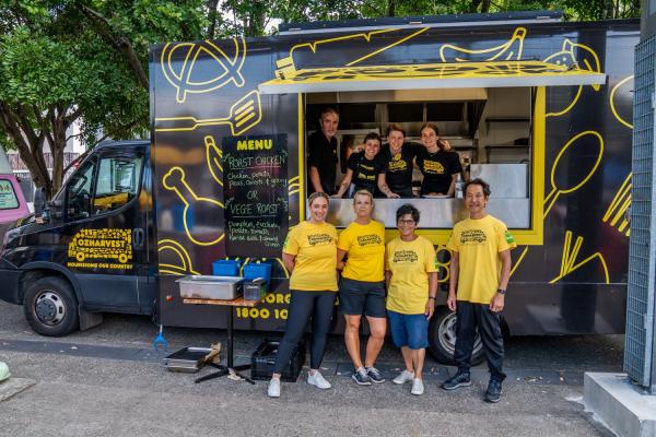 An Oz Harvest team stands in front of one of the catering food trucks available for events. © OzHarvest