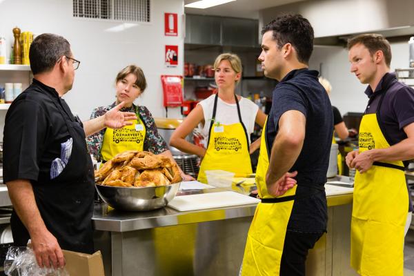 A team learns about cooking to reduce food waste at a Cooking for a Cause experience. © OzHarvest