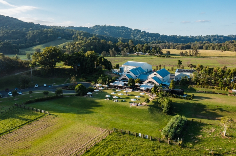A view of the Husk Farm Distillery nestled among green hills, taken by drone. © Husk Farm Distillery