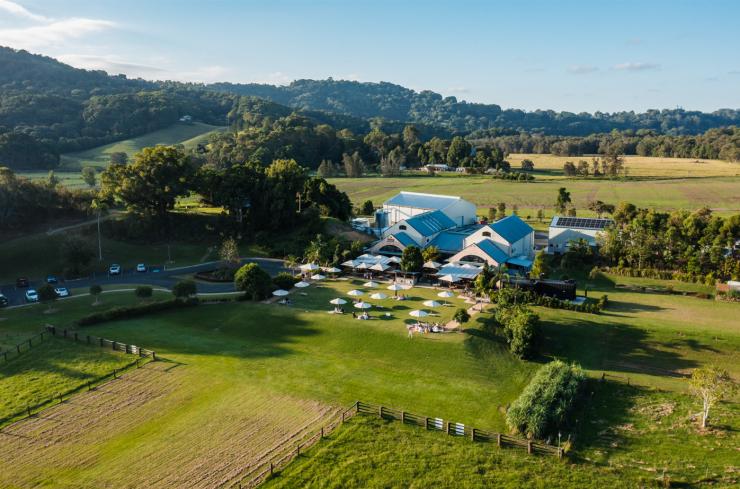 A view of the Husk Farm Distillery nestled among green hills, taken by drone. © Husk Farm Distillery A view of the Husk Farm Distillery nestled among green hills, taken by drone. © Husk Farm Distillery