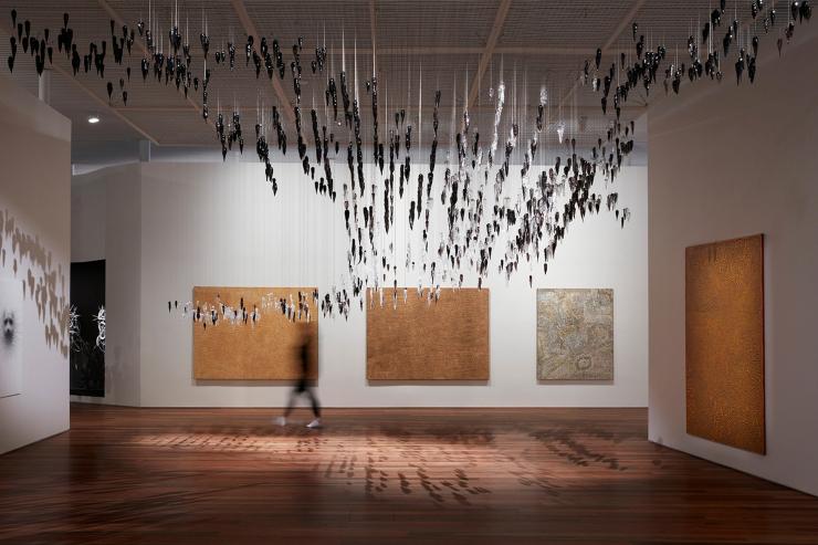 Installation view of the Yiribana Gallery featuring Gallery featuring (from left) YukultjiNapangati 'Untitled' 2005, DoreenReid Nakamarra 'Untitled' 2007,Bobby West Tjupurrula 'Tingari sites around Kiwirrkura' 2015 and RonnieTjampitjinpa 'Tingari fire dreaming at Willinkkarra' 2008, and (top) Yhonnie Scarce 'Death zephyr' 2017 © Ken Leanfore  Installation view of the Yiribana Gallery featuring Gallery featuring (from left) YukultjiNapangati 'Untitled' 2005, DoreenReid Nakamarra 'Untitled' 2007,Bobby West Tjupurrula 'Tingari sites around Kiwirrkura' 2015 and RonnieTjampitjinpa 'Tingari fire dreaming at Willinkkarra' 2008, and (top) Yhonnie Scarce 'Death zephyr' 2017 © Ken Leanfore