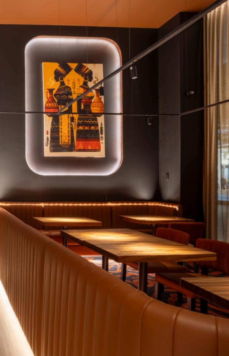 Leather booths and large colourful art set the scene in a moodily-lit restaurant © 7 Cutz