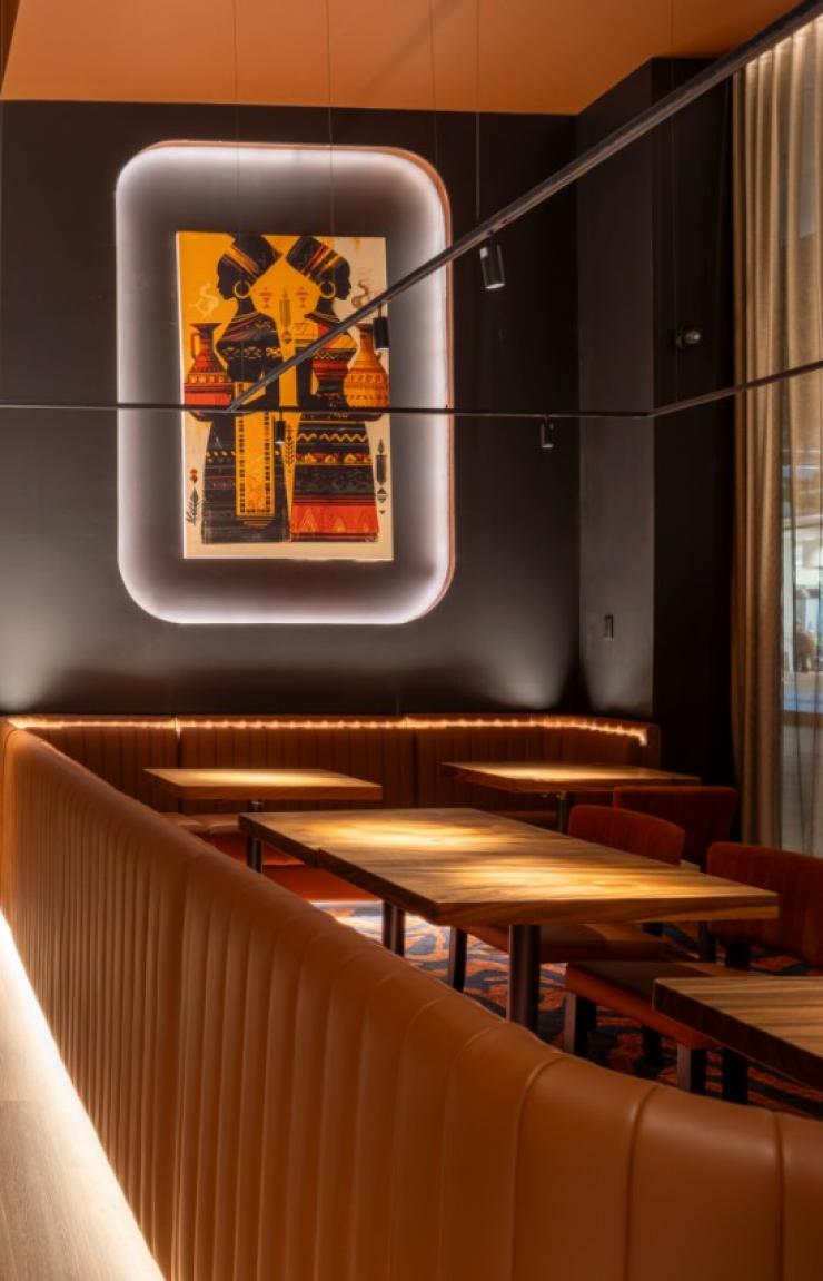 Leather booths and large colourful art set the scene in a moodily-lit restaurant © 7 Cutz