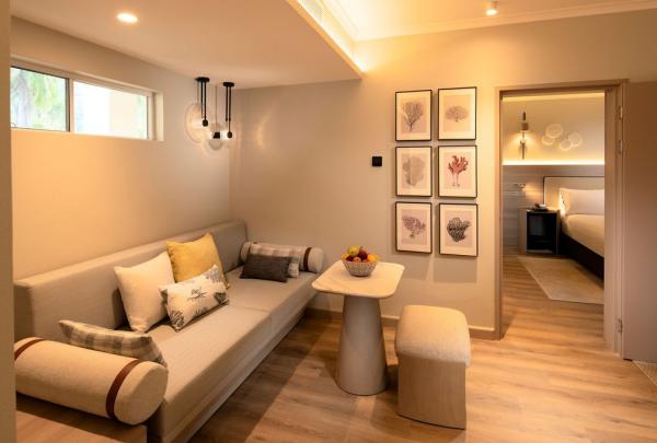 A modern hotel suite with a sitting room leading on to a bedroom. © Hilton Palm Cove Cairns Resort & Spa