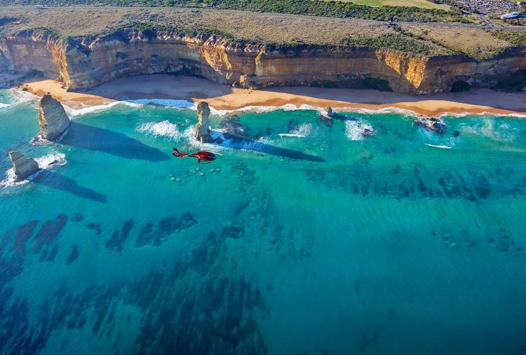 A Microflite Helicopter flies over the 12 Apostles on the Great Ocean Road, Victoria © Microflite