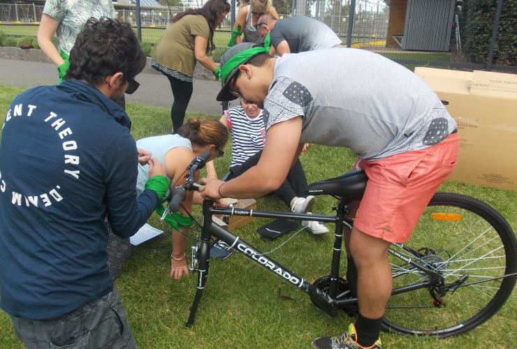 Teams work together to build bikes in the Tykes for Bikes team challenge with Corporate Challenge Events © Corporate Challenge Events