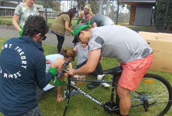 Teams work together to build bikes in the Tykes for Bikes team challenge with Corporate Challenge Events © Corporate Challenge Events