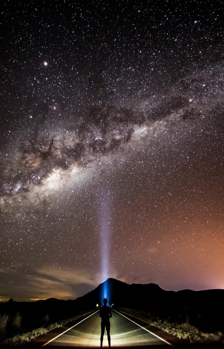 Stargazer with a head torch looking up at the milky way © Tourism and Events Queensland/Sean Scott Stargazer with a head torch looking up at the milky way © Tourism and Events Queensland/Sean Scott