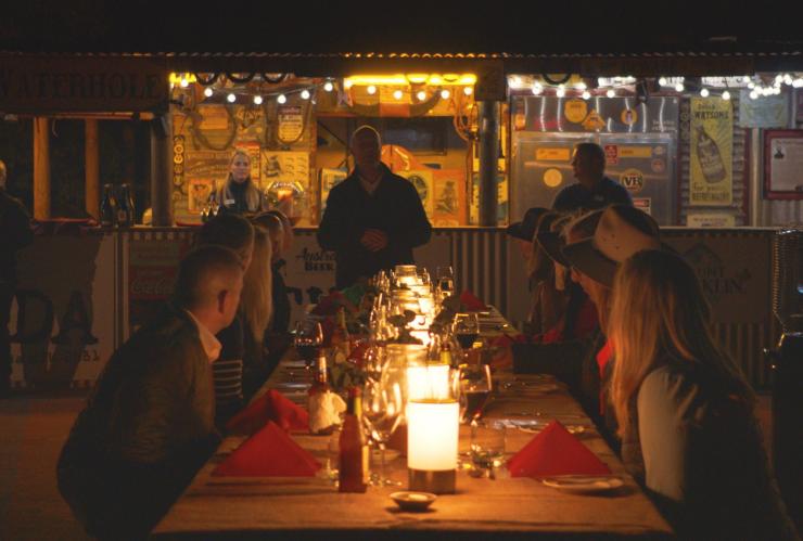 Outdoor dining at the Camel Farm, Uluru Camel Tours © Tourism Australia