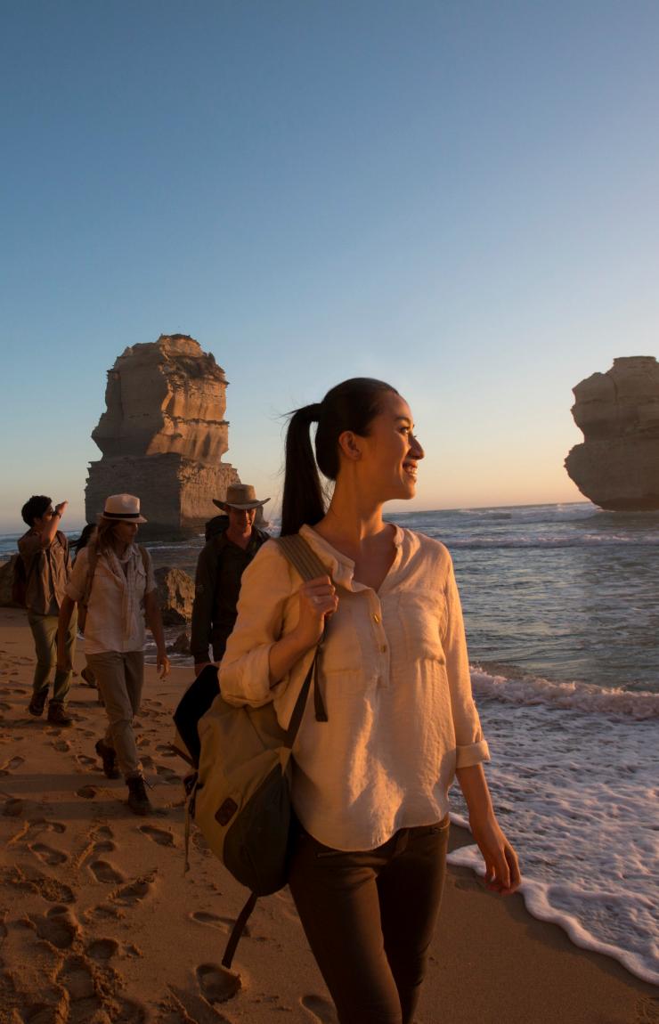 A group walks on the beach admiring the Twelve Apostles, Victoria © Tourism Australia A group walks on the beach admiring the Twelve Apostles, Victoria © Tourism Australia