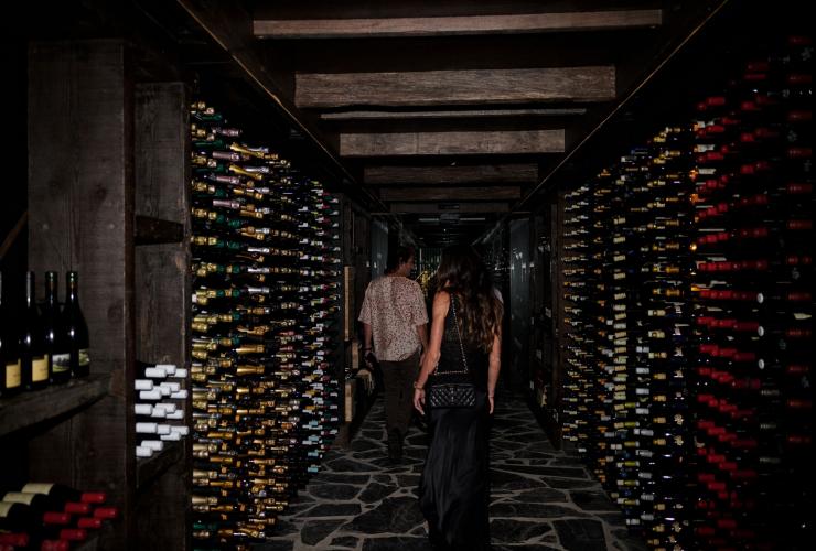 A group walks through the wine racks at The Belongil, Byron Bay, New South Wales © The Belongil