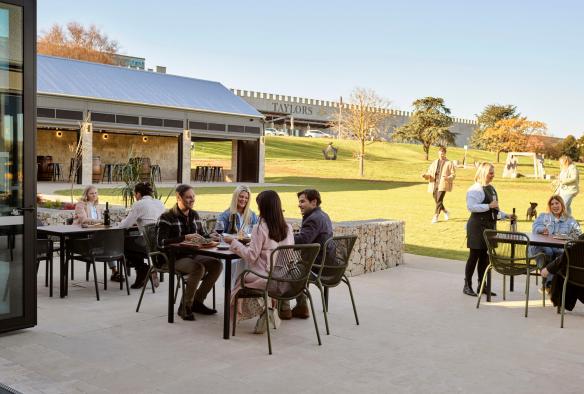 The cellar grounds showing a terrace with people seated and lawn at Taylors Wines, Clare Valley, South Australia © Taylors Wines