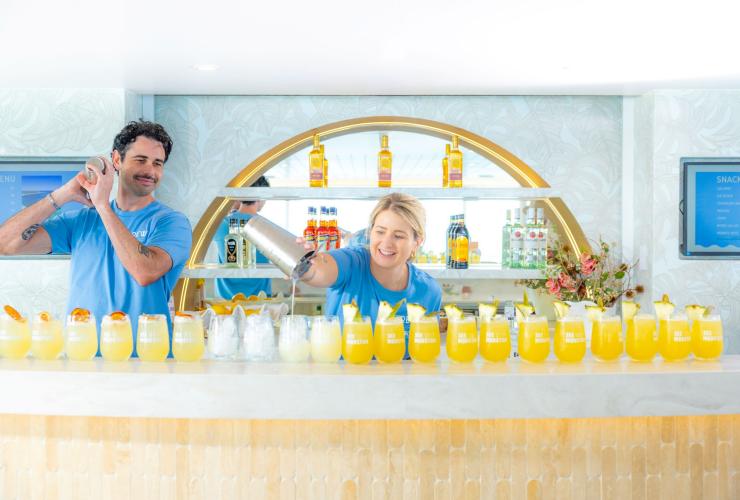 Bar staff on board Spirit of Mulgumpin pour a line of drinks, Queensland © See Morton