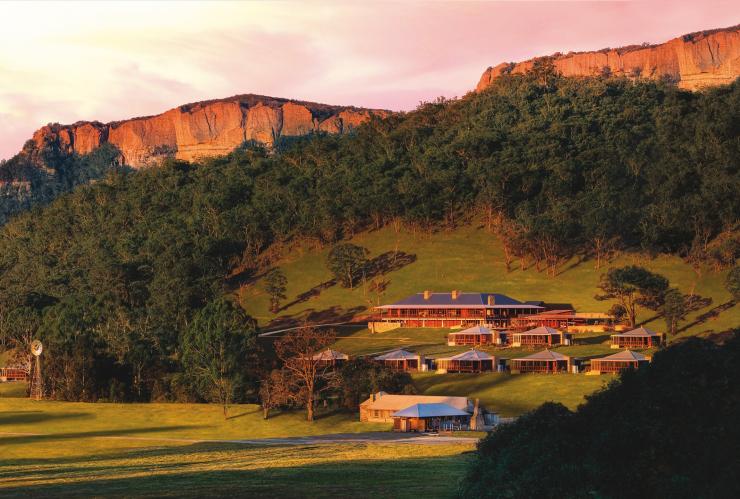 Golden sunset bathes Emirates Wolgan Valley, a Ritz Carlton Lodge homestead and suites nestled under an escarpment, Blue Mountains, New South Wales © Emirates Wolgan Valley, a Ritz-Carlton Lodge