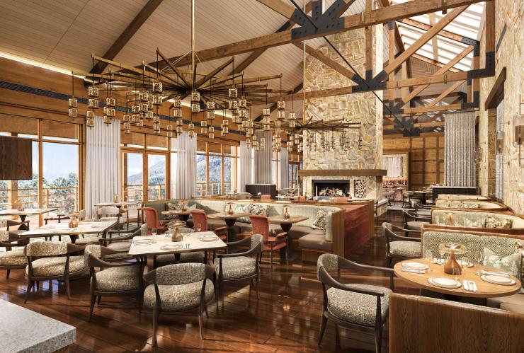 The restaurant showing tables and chairs, banquettes lining the walls and wood and stone finishes at Emirates Wolgan Valley, a Ritz-Carlton Lodge, Blue Mountains, New South Wales © Emirates Wolgan Valley, a Ritz-Carlton Lodge