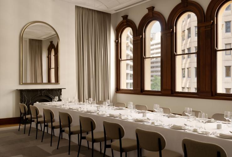 Heritage window frames and a long table set up for dining, The Lands by Capella, Bridge Street Sydney, New South Wales © Timothy Kaye