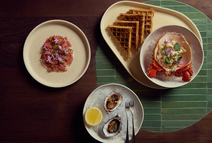 Dishes plated up on a table at Haven, Mondrian, Gold Coast, Queensland © Content Lion