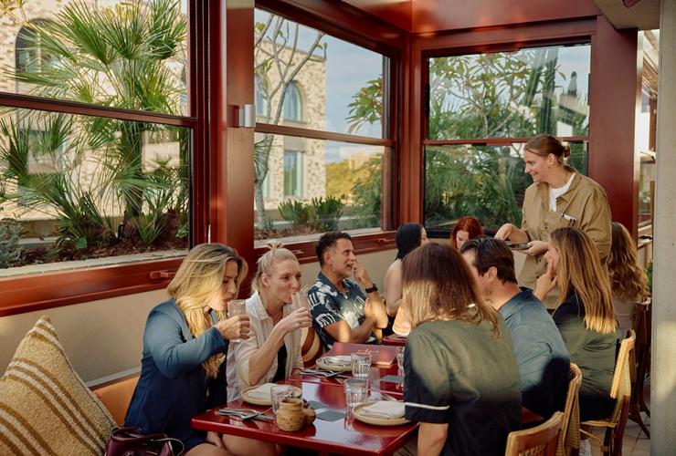 A group sipping drinks and giving their order at Lottie, Lottie, Sydney, New South Wales © Lottie