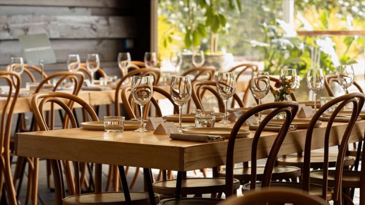 Long wooden tables and chairs set for dining at Ondeen, Adelaide Hills, South Australia © Ondeen
