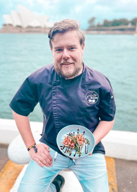 Matt Atkins, Owner and Executive chef with a plate of seafood and the Sydney Opera House in the background, Sydney, New South Wales © Plate Hospitality Group