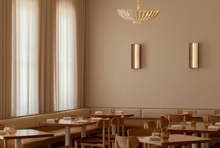 Floor to ceiling curtains and bespoke lighting adorn the neutral tones of Esmay © Esmay