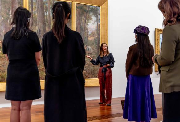A group listens to the NGV explain historic Australian art at NGV Australia © National Gallery of Victoria