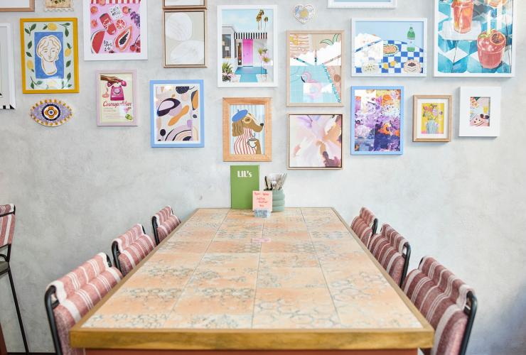 The colourful tiled tables and artwork on the wall in the rooftop bar. © Shot by Thom