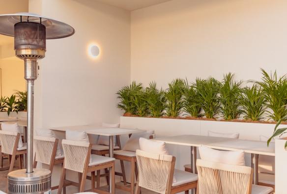 A leafy nook with tables and chairs set for an event at Siroco. © Siroco