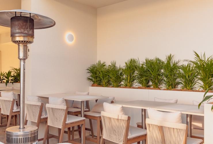A leafy nook with tables and chairs set for an event at Siroco. © Siroco