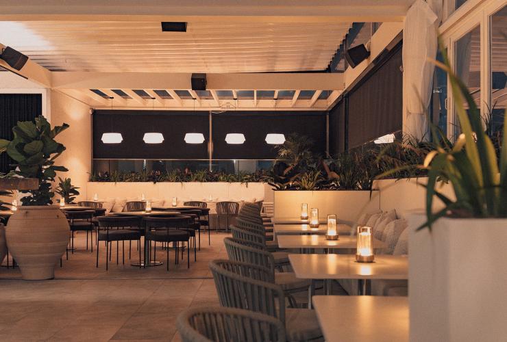 Siroco at night showing soft lights on the tables and dark curtains enclosing the venue. © Siroco