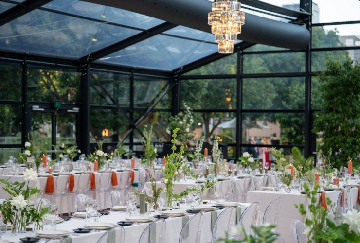 Long table settings with white linen cloths, contrasting linens and florals for an event at the Glo House © Glo Events