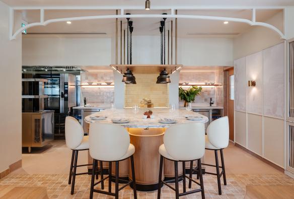 An extendable marble table setting, with a woodfire opening and four bar chairs for tastings © Adam Gibson