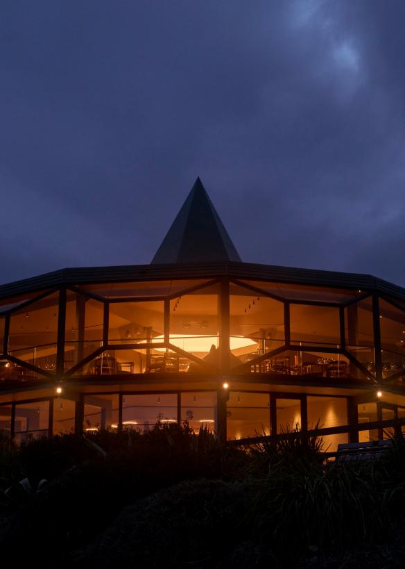 The double storey Modernist structure of Lunetta lit up at night © Lillie Thompson