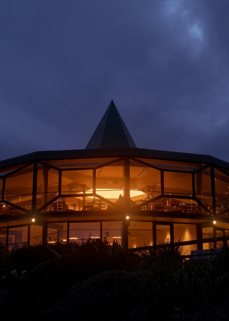 The double storey Modernist structure of Lunetta lit up at night © Lillie Thompson